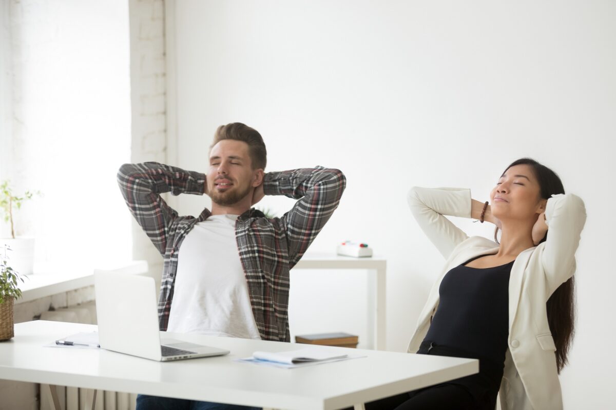 Relaxed,Asian,And,Caucasian,Office,Colleagues,Enjoy,Break,At,Workplace